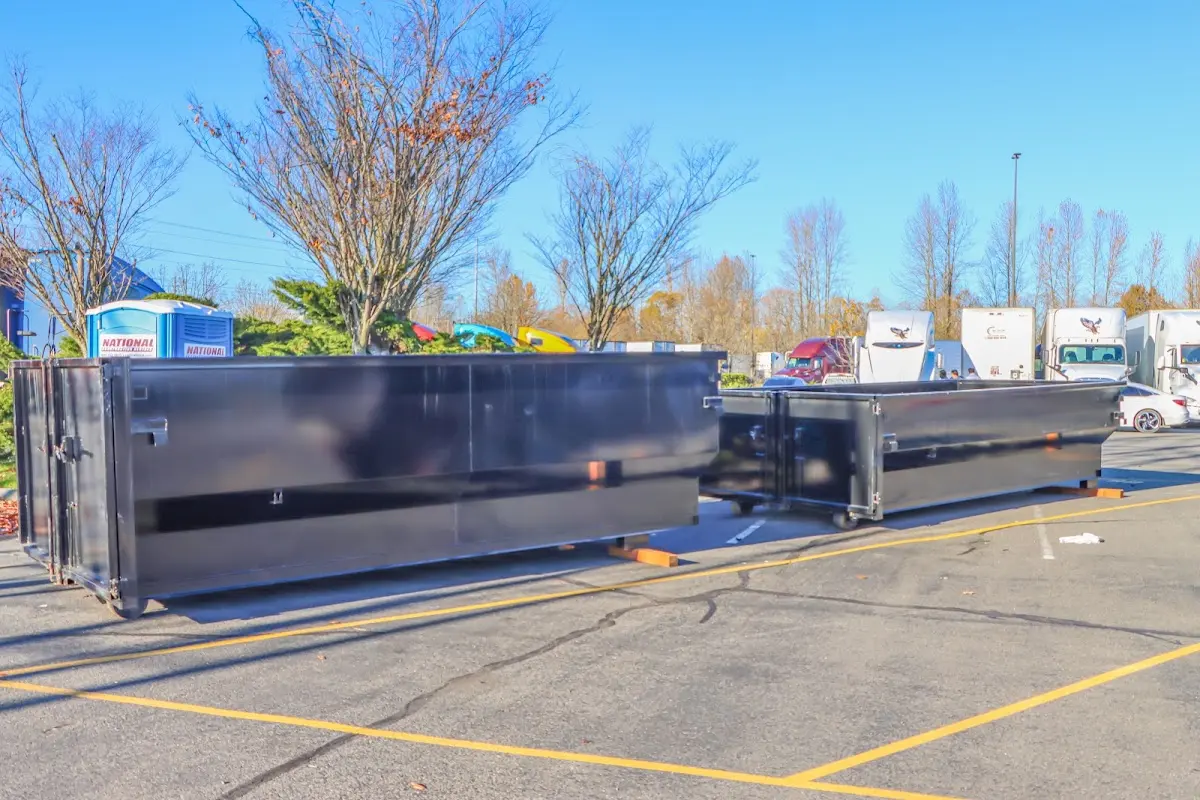 Professional dumpster rental service with roll-off container on residential driveway in Ruidoso